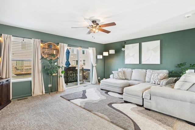 carpeted living room featuring ceiling fan