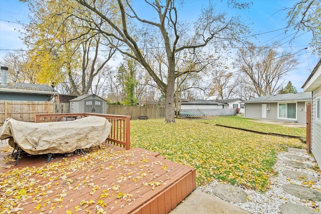 view of yard featuring a storage shed and a wooden deck