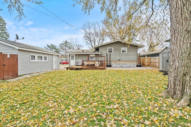 back of property featuring a yard and a deck