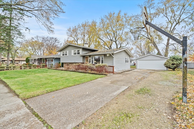 tri-level home with a garage, an outdoor structure, and a front lawn