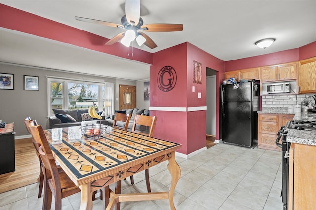 tiled dining space with ceiling fan