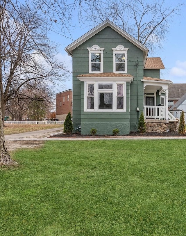 view of front of home with a porch and a front yard