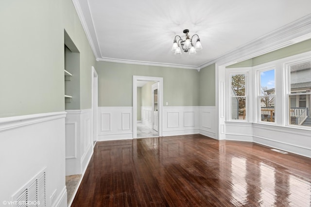 unfurnished dining area with a notable chandelier, wood-type flooring, and ornamental molding