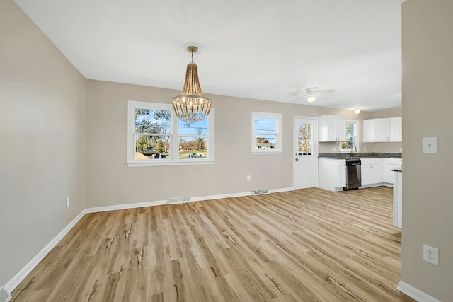 interior space featuring light hardwood / wood-style flooring, ceiling fan with notable chandelier, and sink