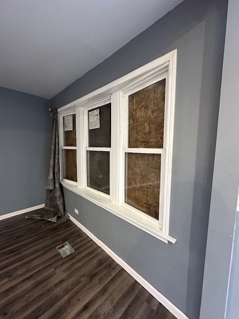 empty room featuring dark wood-type flooring