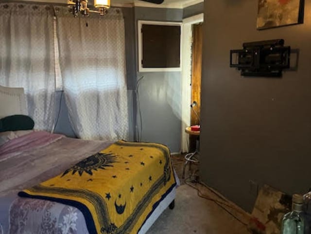 bedroom featuring carpet and an inviting chandelier