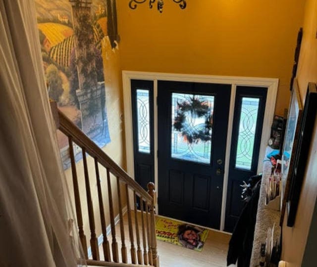 entryway featuring a healthy amount of sunlight and a chandelier