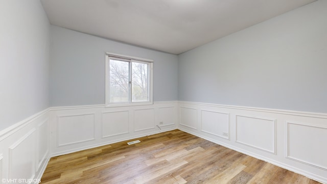 unfurnished room with light hardwood / wood-style floors