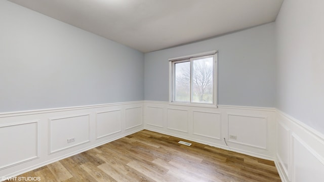 empty room with light hardwood / wood-style flooring