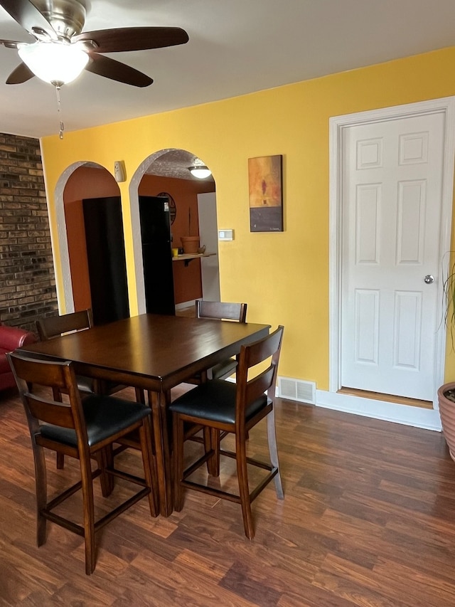 dining space featuring ceiling fan and dark wood-type flooring