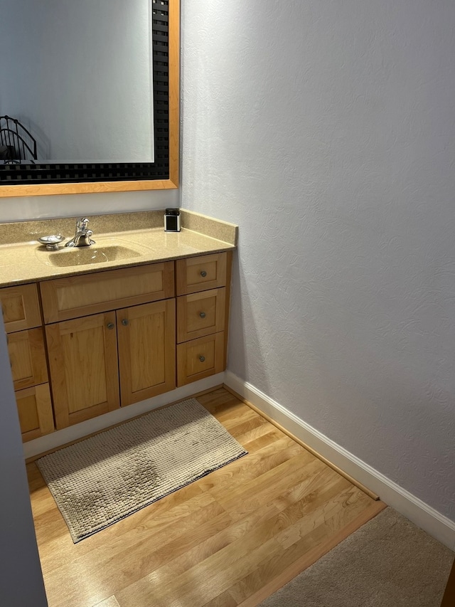 bathroom with hardwood / wood-style floors and vanity