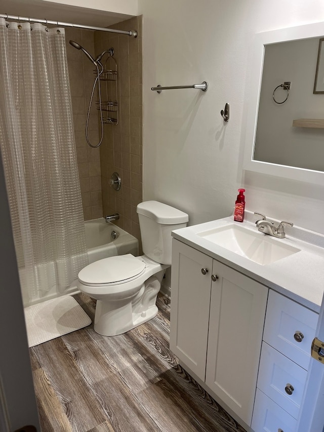 full bathroom featuring hardwood / wood-style floors, vanity, toilet, and shower / tub combo with curtain