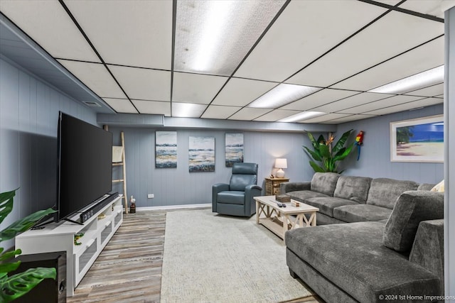 living room featuring a drop ceiling and wood-type flooring