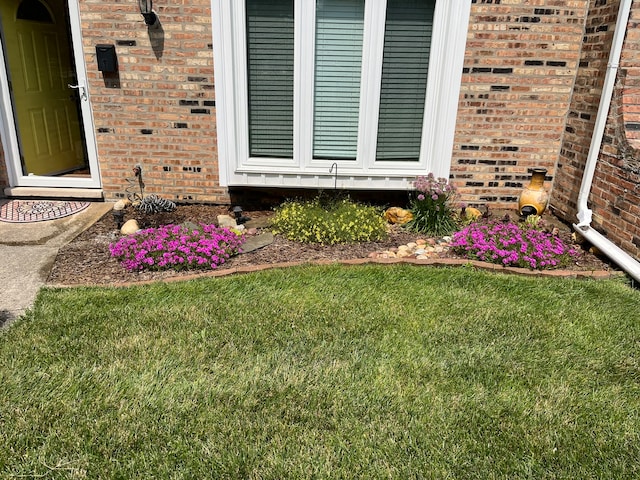 entrance to property featuring a lawn