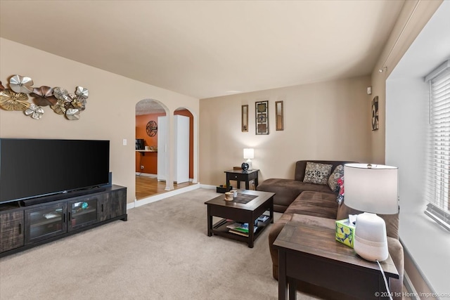 living room featuring light carpet and plenty of natural light