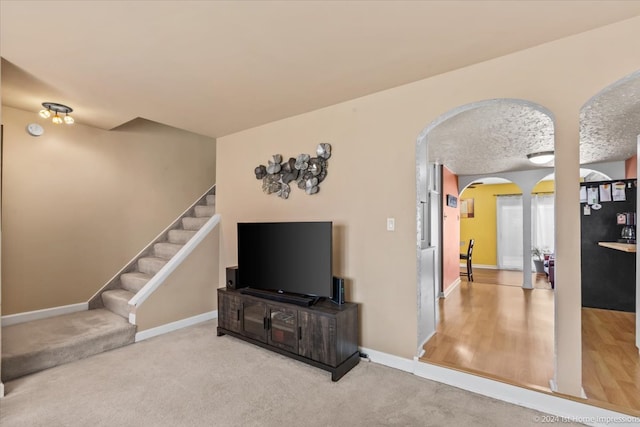 living room featuring hardwood / wood-style floors and a textured ceiling