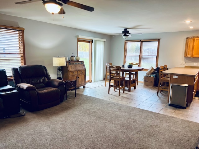 living room featuring ceiling fan, plenty of natural light, and light tile patterned flooring