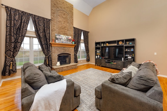 living room featuring a fireplace, hardwood / wood-style flooring, and lofted ceiling