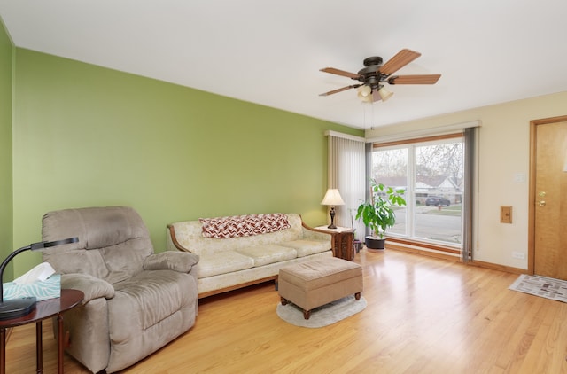 living room featuring ceiling fan and wood-type flooring