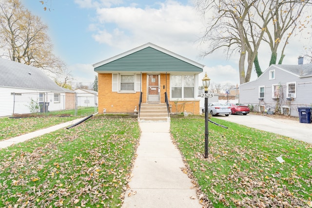 bungalow-style house featuring a front yard