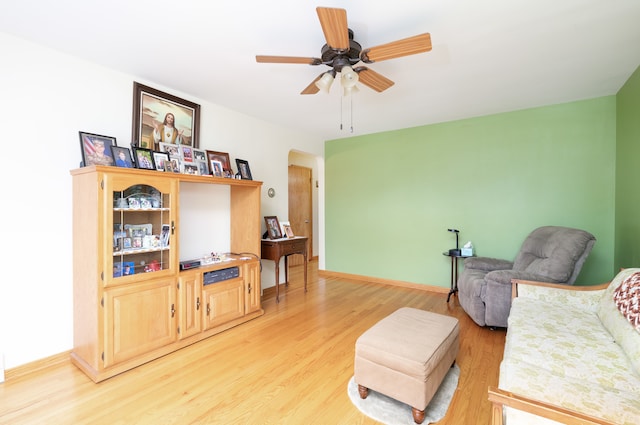 living room featuring ceiling fan and light hardwood / wood-style flooring