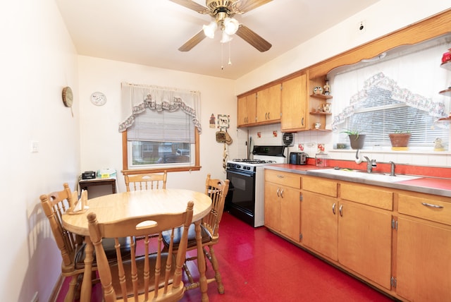 kitchen with backsplash, ceiling fan, black gas stove, and sink