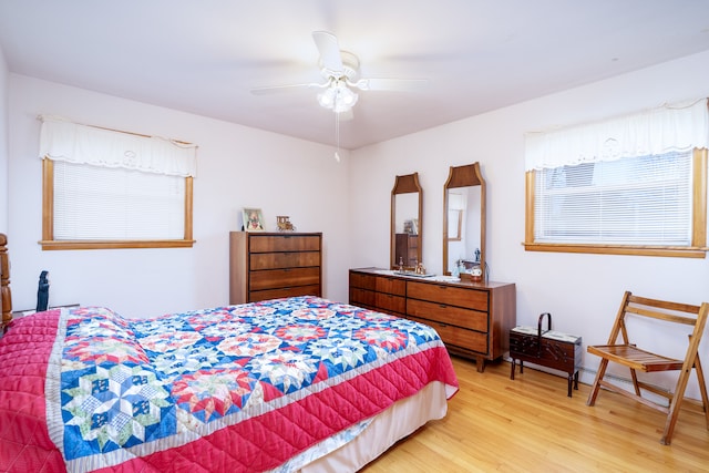 bedroom with ceiling fan and light hardwood / wood-style flooring