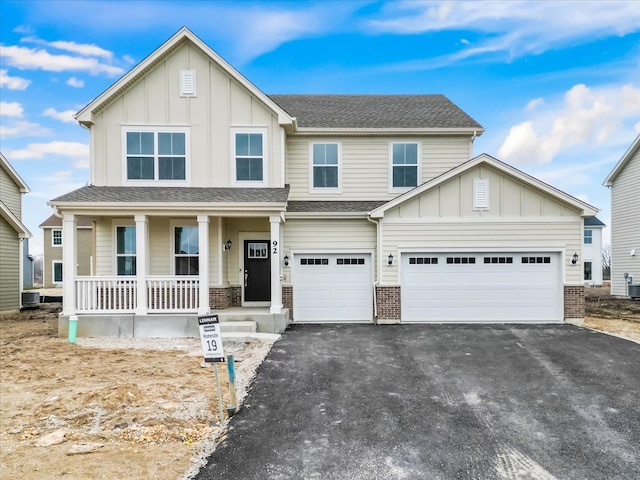 view of front of home featuring a porch and a garage