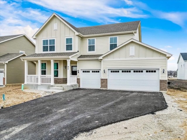 view of front of house with covered porch and a garage