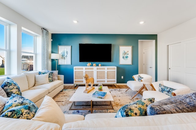 living room with recessed lighting, baseboards, and wood finished floors