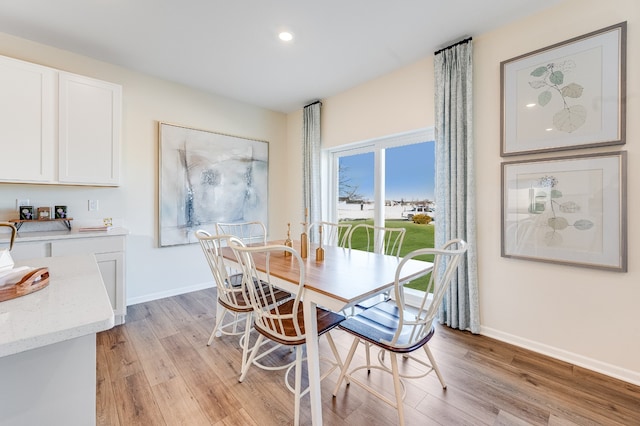dining room featuring recessed lighting, light wood-style flooring, and baseboards