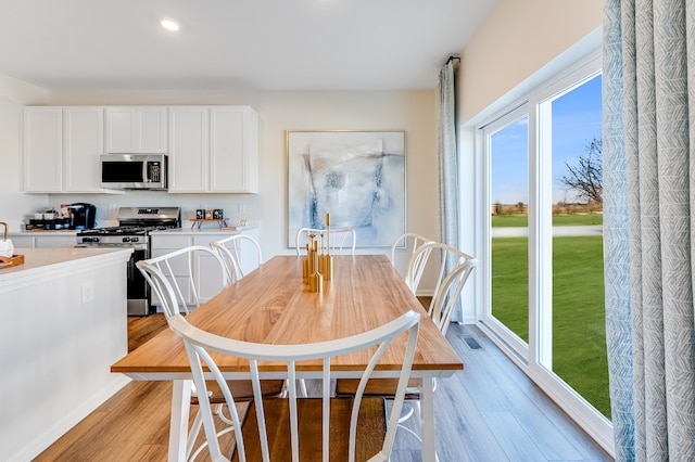 dining area with recessed lighting and light wood-type flooring