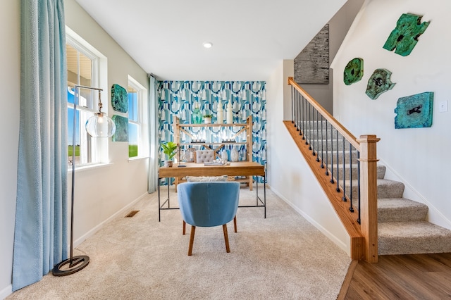 carpeted office featuring visible vents and baseboards