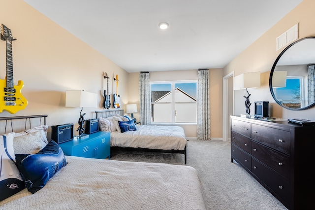 bedroom with baseboards, visible vents, and carpet floors