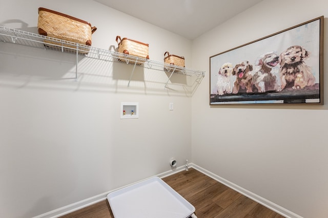 laundry area featuring dark wood-type flooring, laundry area, washer hookup, and baseboards