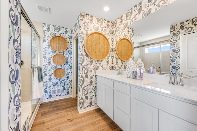 bathroom featuring a shower with door, vanity, and hardwood / wood-style floors