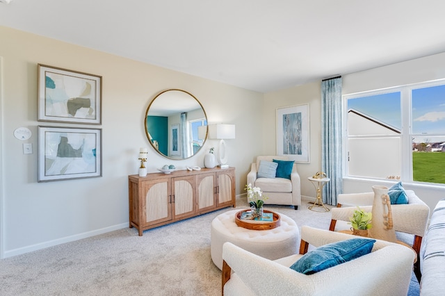living area with baseboards and light carpet
