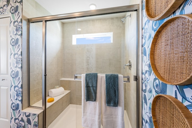 bathroom featuring a shower with shower door