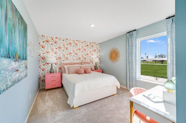 carpeted bedroom with wallpapered walls, an accent wall, baseboards, and recessed lighting
