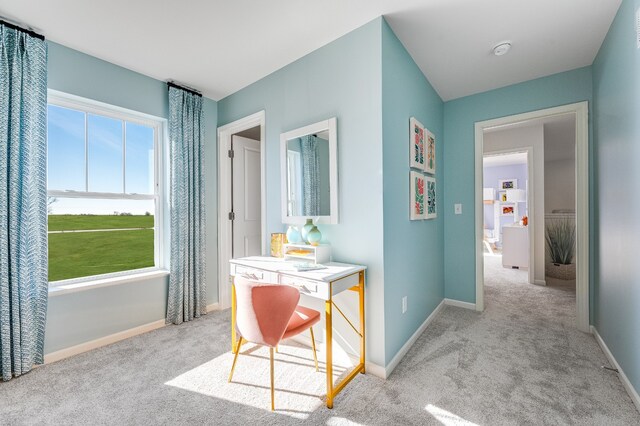corridor with carpet flooring and baseboards