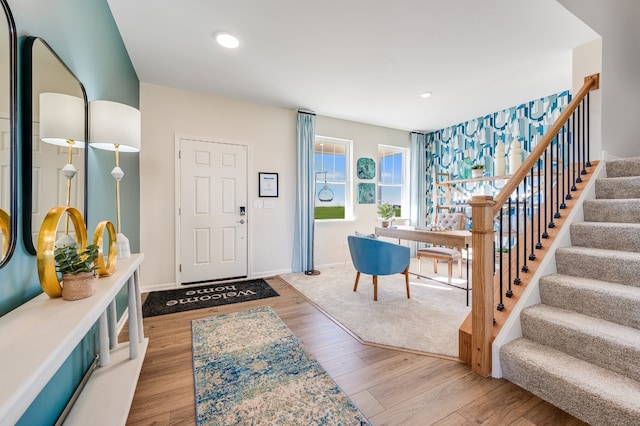entryway featuring wood finished floors, recessed lighting, baseboards, and stairway
