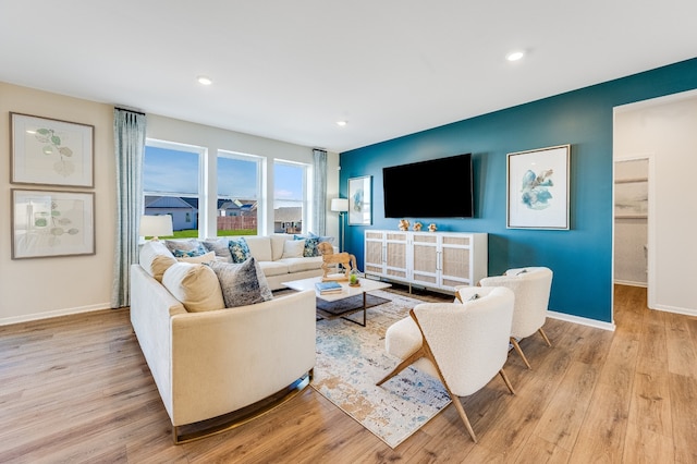 living room featuring light wood-style floors, baseboards, and recessed lighting