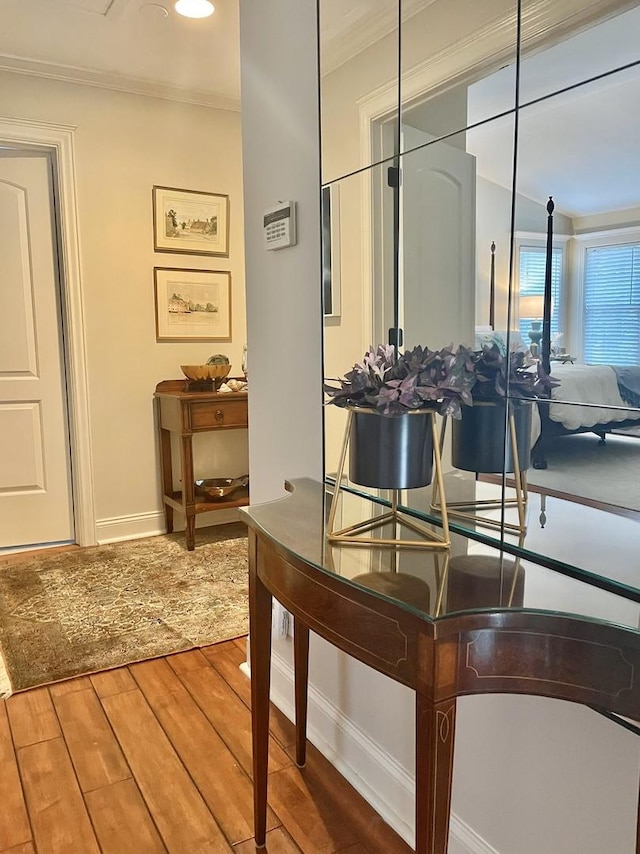 interior details featuring hardwood / wood-style flooring and crown molding