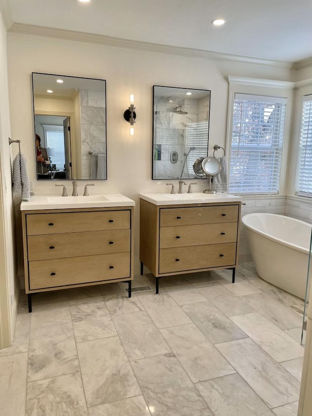 bathroom with plus walk in shower, vanity, and crown molding