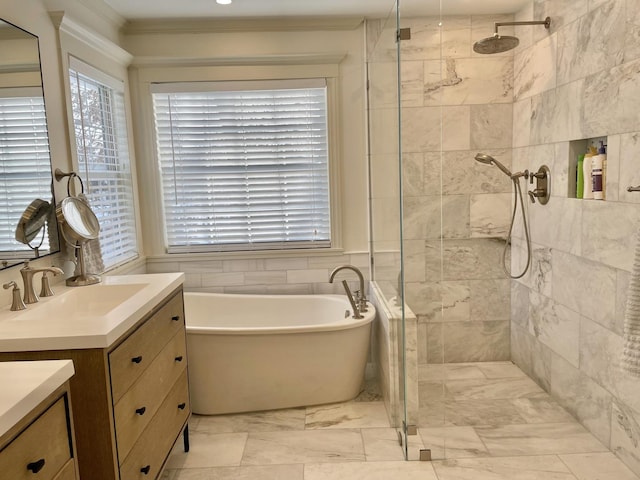 bathroom with vanity and shower with separate bathtub