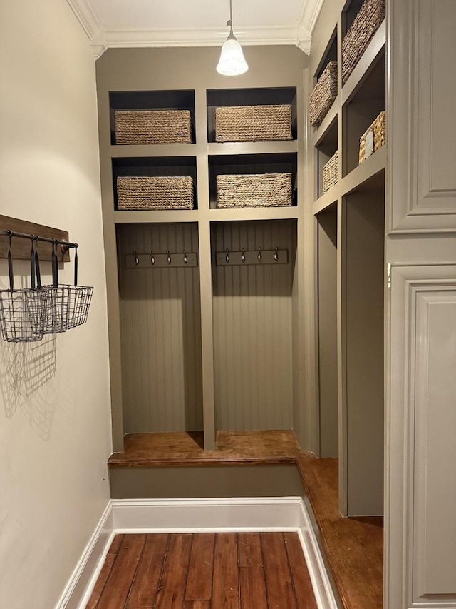 mudroom with dark wood-type flooring and ornamental molding