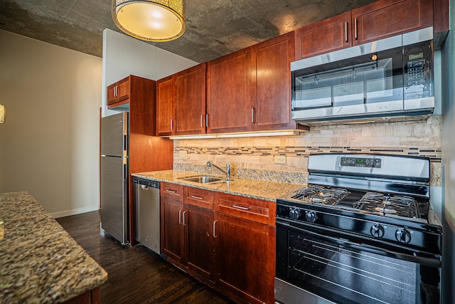 kitchen featuring sink, dark wood-type flooring, light stone counters, backsplash, and appliances with stainless steel finishes