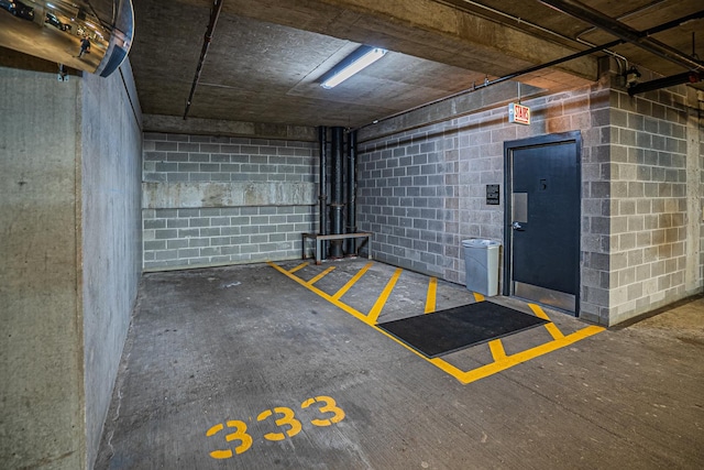 parking garage featuring concrete block wall