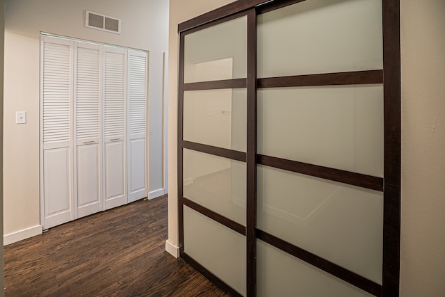 hallway featuring dark hardwood / wood-style flooring