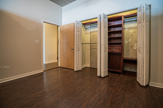 unfurnished bedroom featuring dark hardwood / wood-style flooring